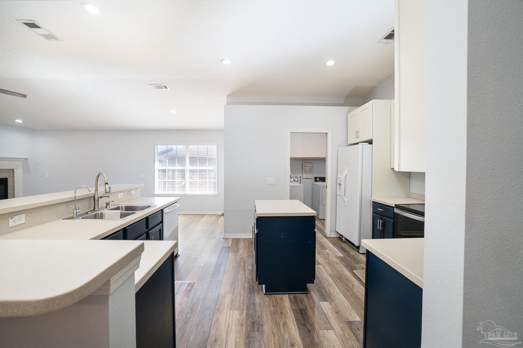 4836 Timber Ridge Drive Pace, FL 32571 - Photo 16 of 46 a kitchen with stainless steel appliances kitchen island granite countertop a sink stove and refrigerator