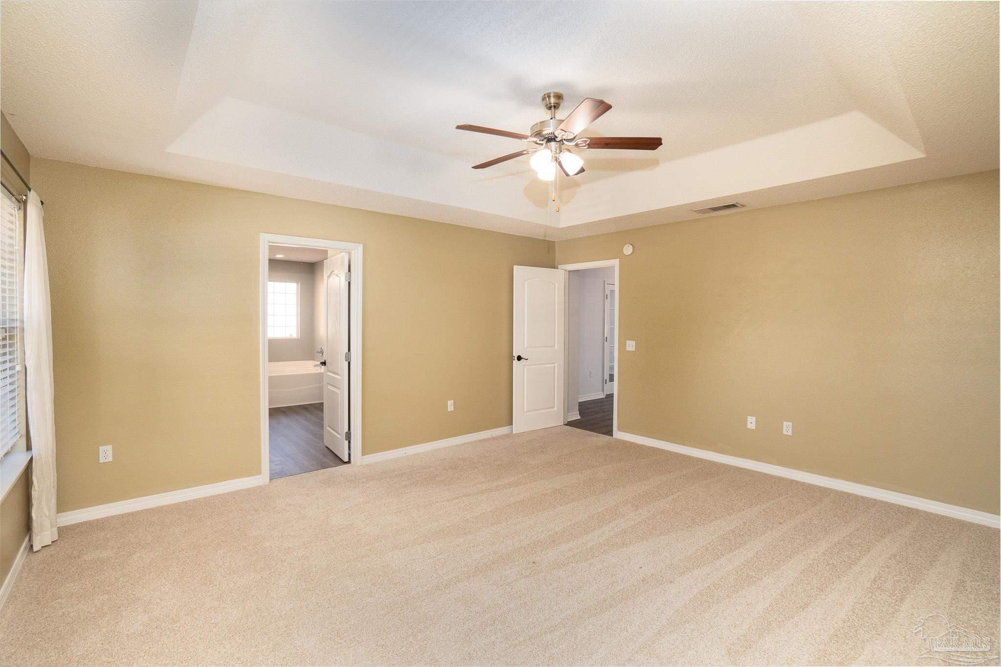 4836 Timber Ridge Drive Pace, FL 32571 - Photo 18 of 46 a view of a room with a ceiling fan