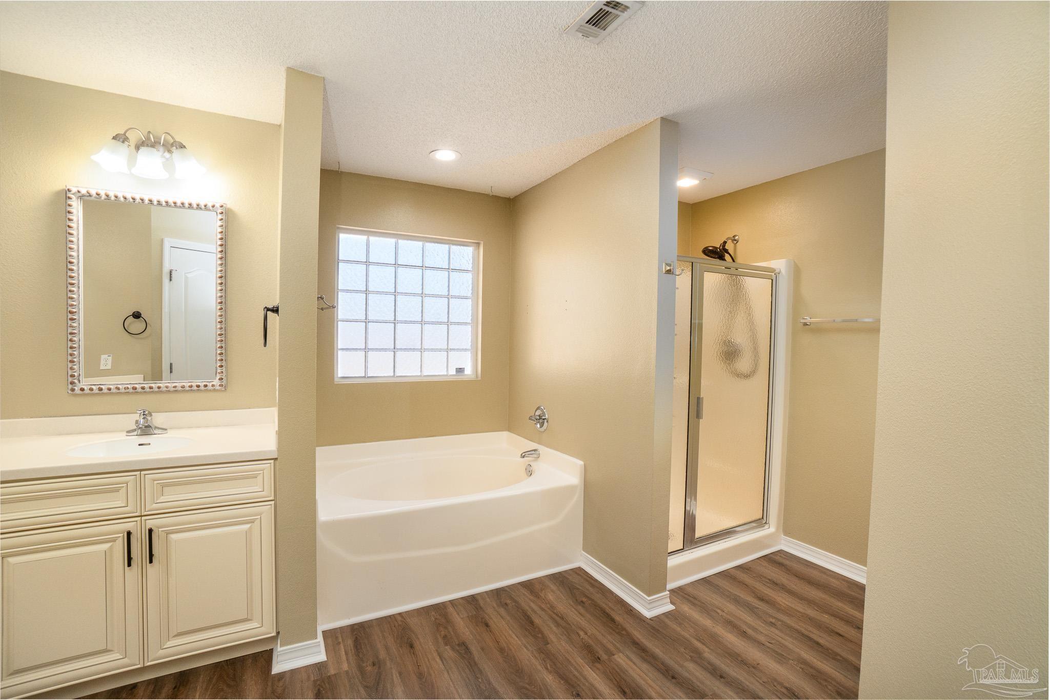 4836 Timber Ridge Drive Pace, FL 32571 - Photo 21 of 46 a bathroom with a bathtub and a sink