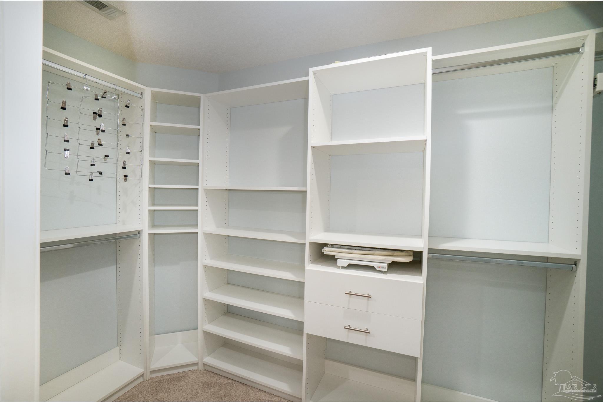 4836 Timber Ridge Drive Pace, FL 32571 - Photo 22 of 46 a view of walk in closet with empty racks