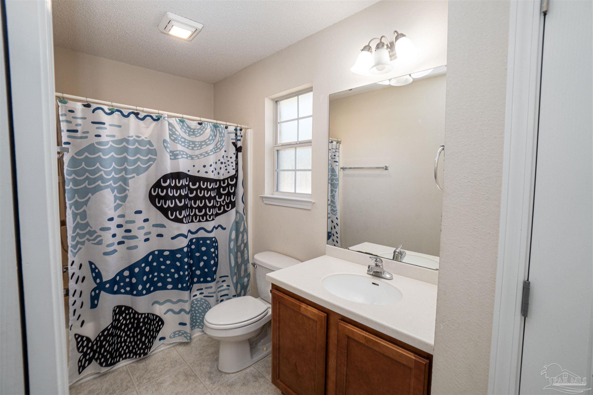 4836 Timber Ridge Drive Pace, FL 32571 - Photo 25 of 46 a bathroom with a sink toilet and shower