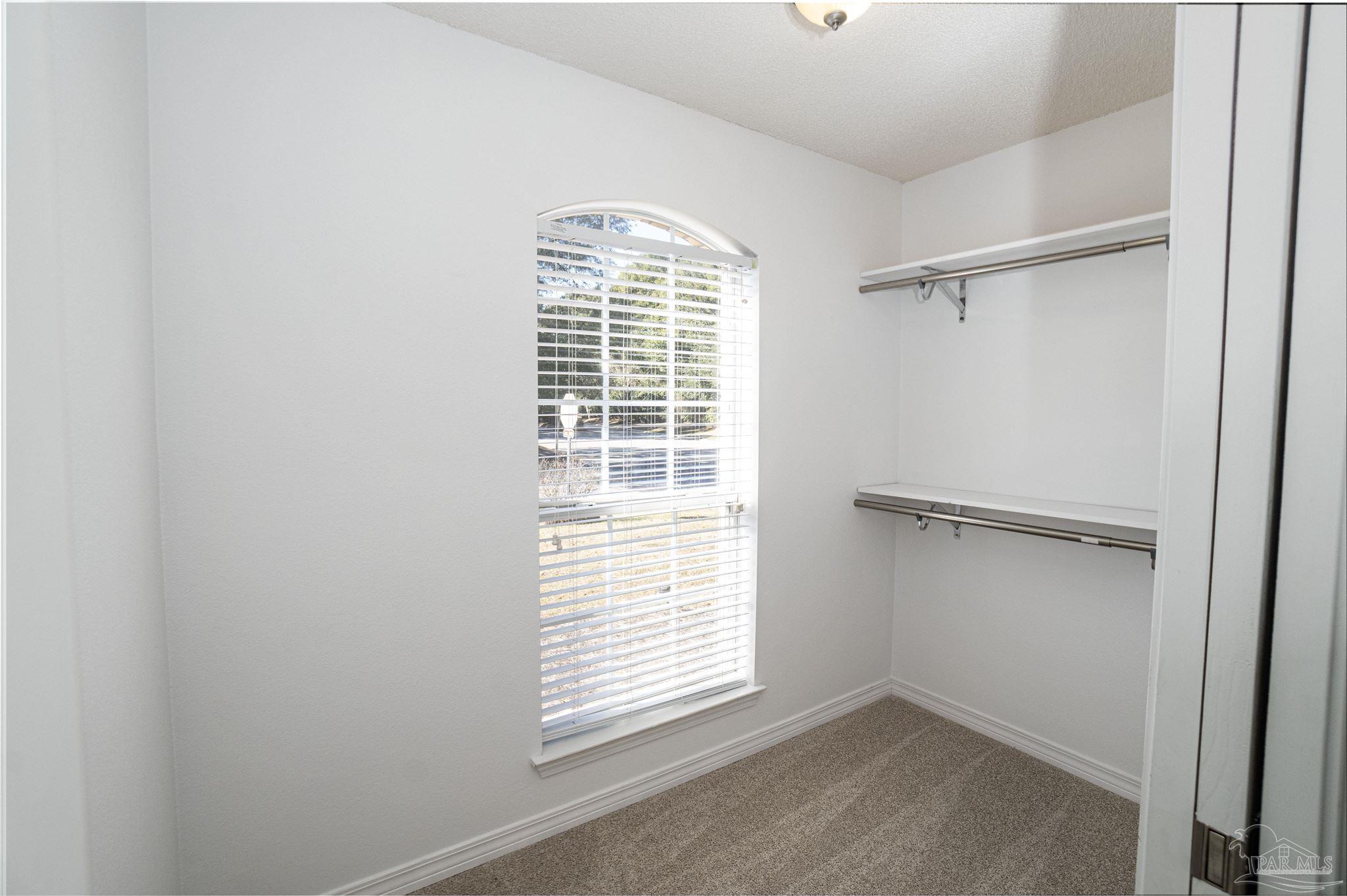 4836 Timber Ridge Drive Pace, FL 32571 - Photo 26 of 46 a view of an empty room with a window and closet area