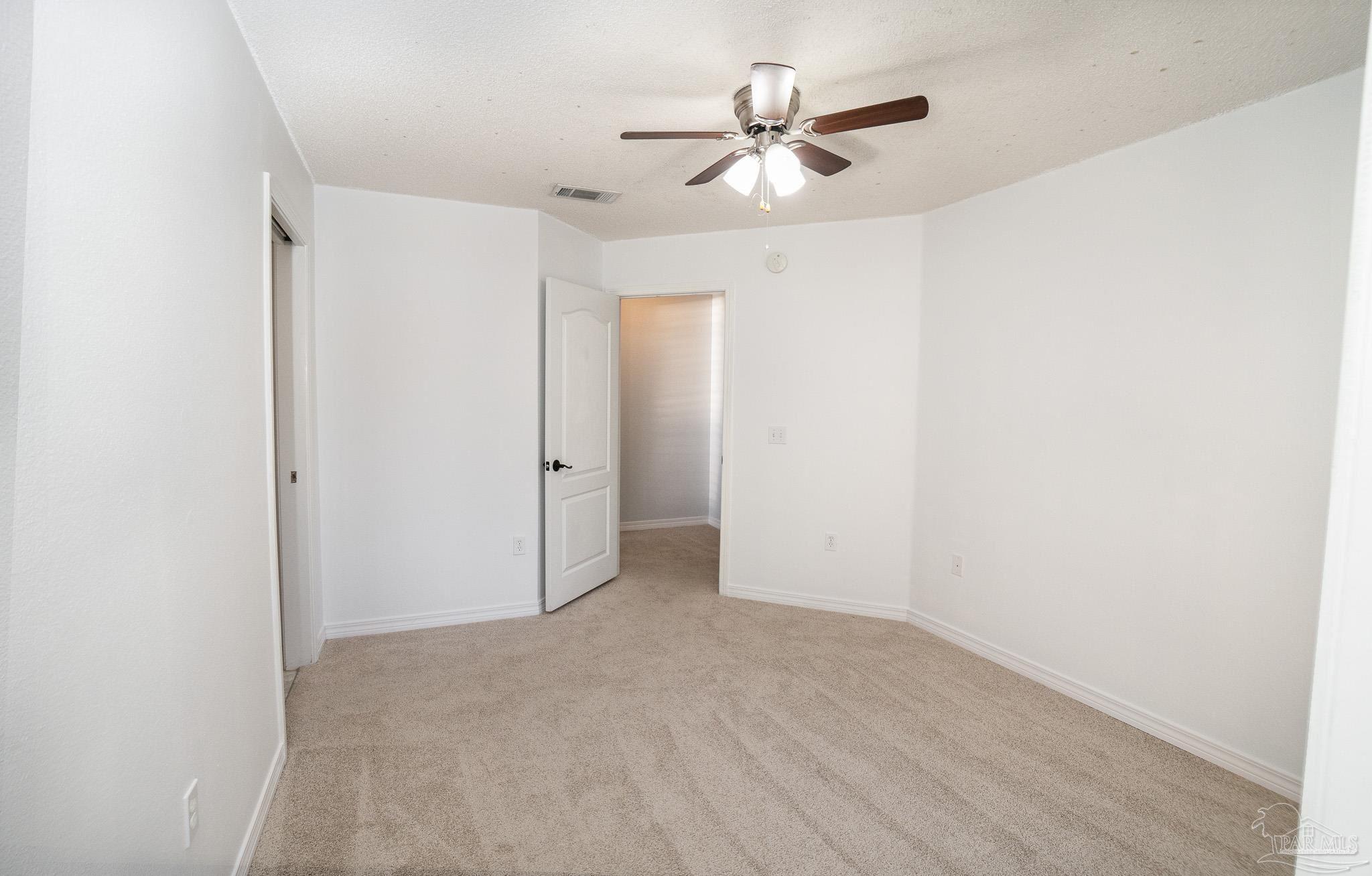 4836 Timber Ridge Drive Pace, FL 32571 - Photo 27 of 46 an empty room with a ceiling fan and a window