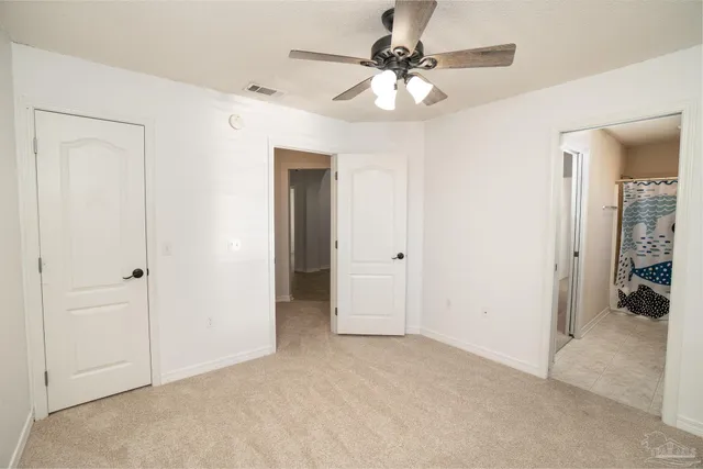 a view of a chandelier fan and closet area