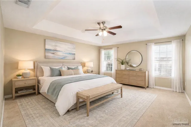 a bedroom with a bed couch and window