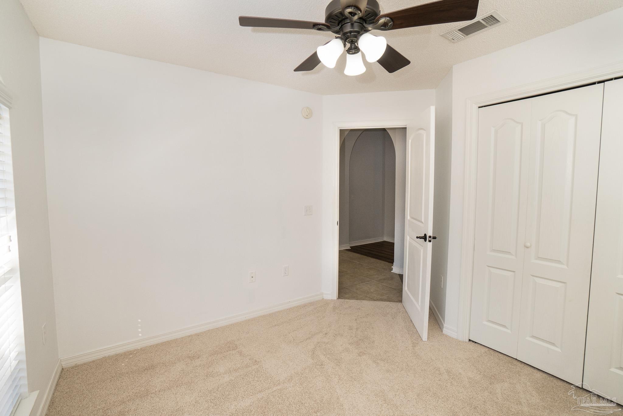 4836 Timber Ridge Drive Pace, FL 32571 - Photo 31 of 46 an empty room with a ceiling fan and a window