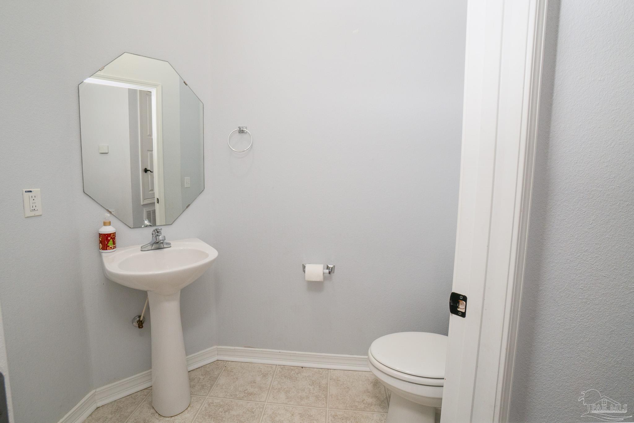 4836 Timber Ridge Drive Pace, FL 32571 - Photo 34 of 46 a bathroom with a sink a toilet and a mirror