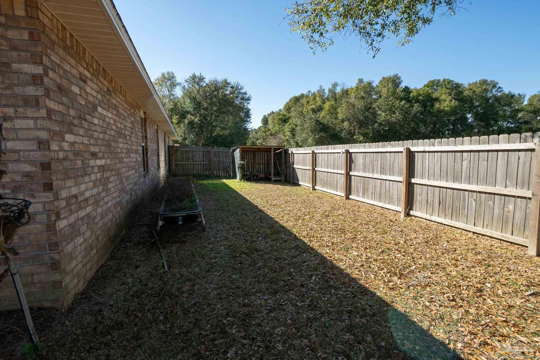4836 Timber Ridge Drive Pace, FL 32571 - Photo 40 of 46 a view of a balcony with wooden floor and fence