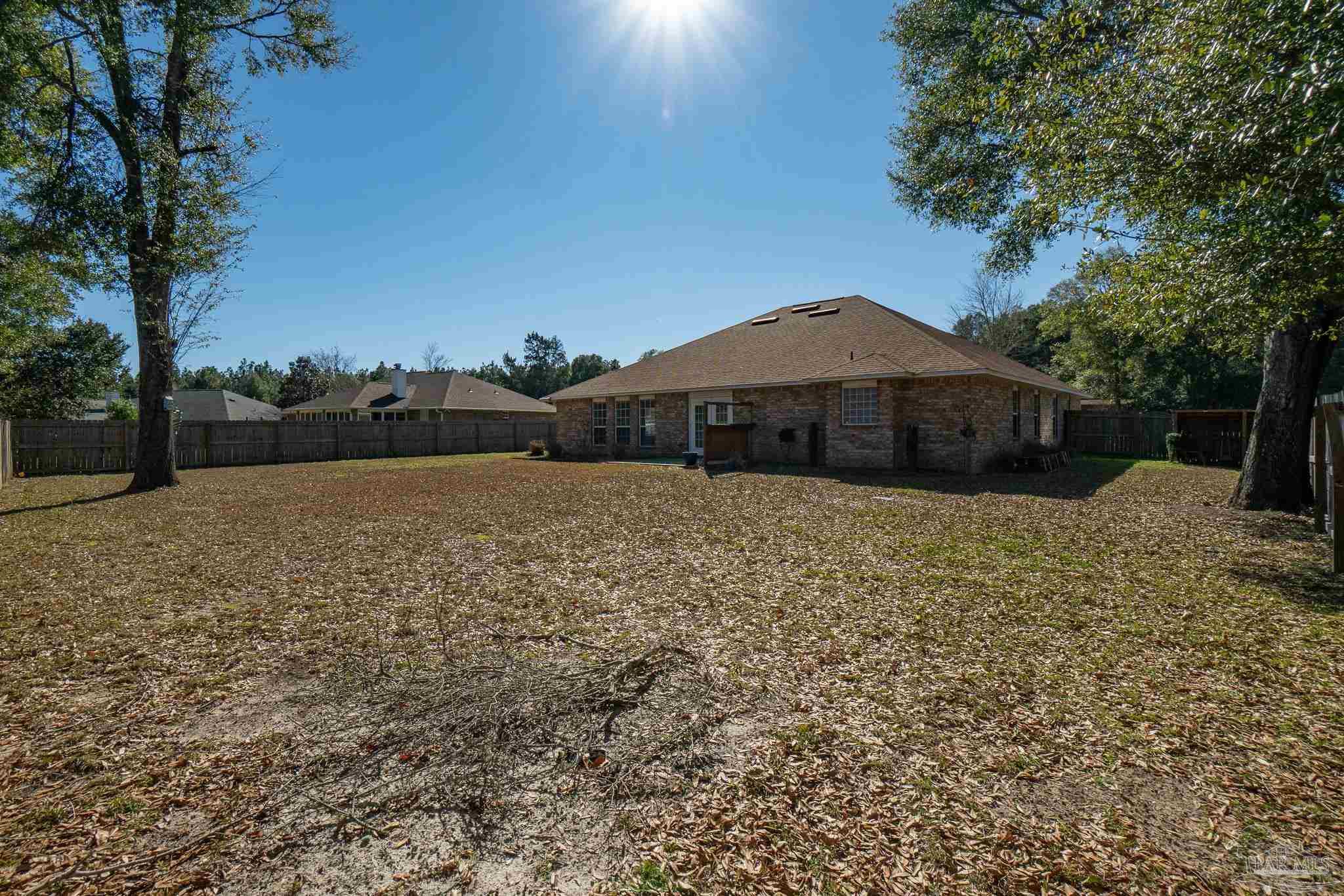 4836 Timber Ridge Drive Pace, FL 32571 - Photo 41 of 46 a house with green field in front of it