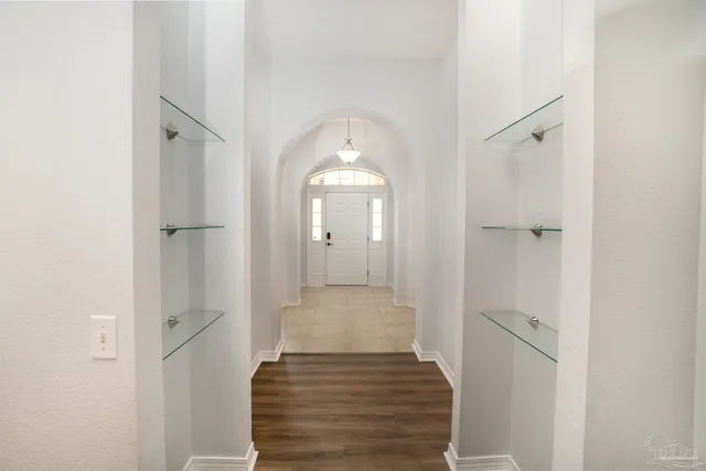 a view of a hallway view with wooden floor and staircase