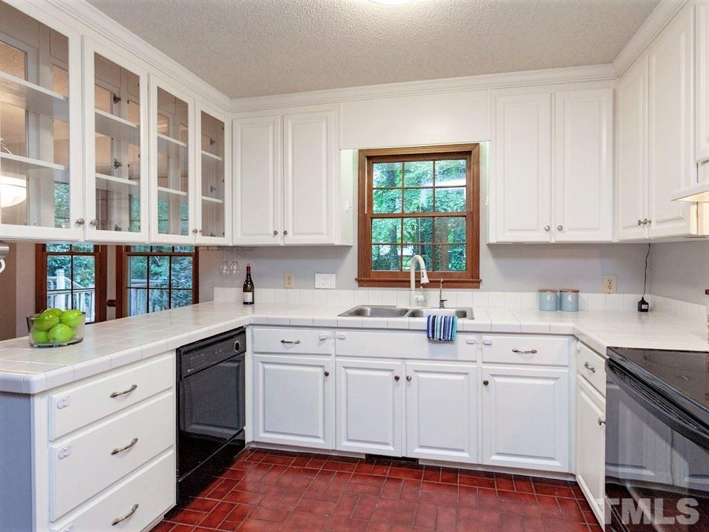 3208 Brennan Drive Raleigh, NC 27613 - Photo 3 of 25 a kitchen with a sink stove and cabinets