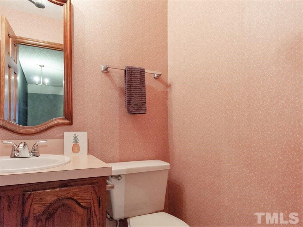 3208 Brennan Drive Raleigh, NC 27613 - Photo 22 of 25 a bathroom with a sink mirror vanity and toilet