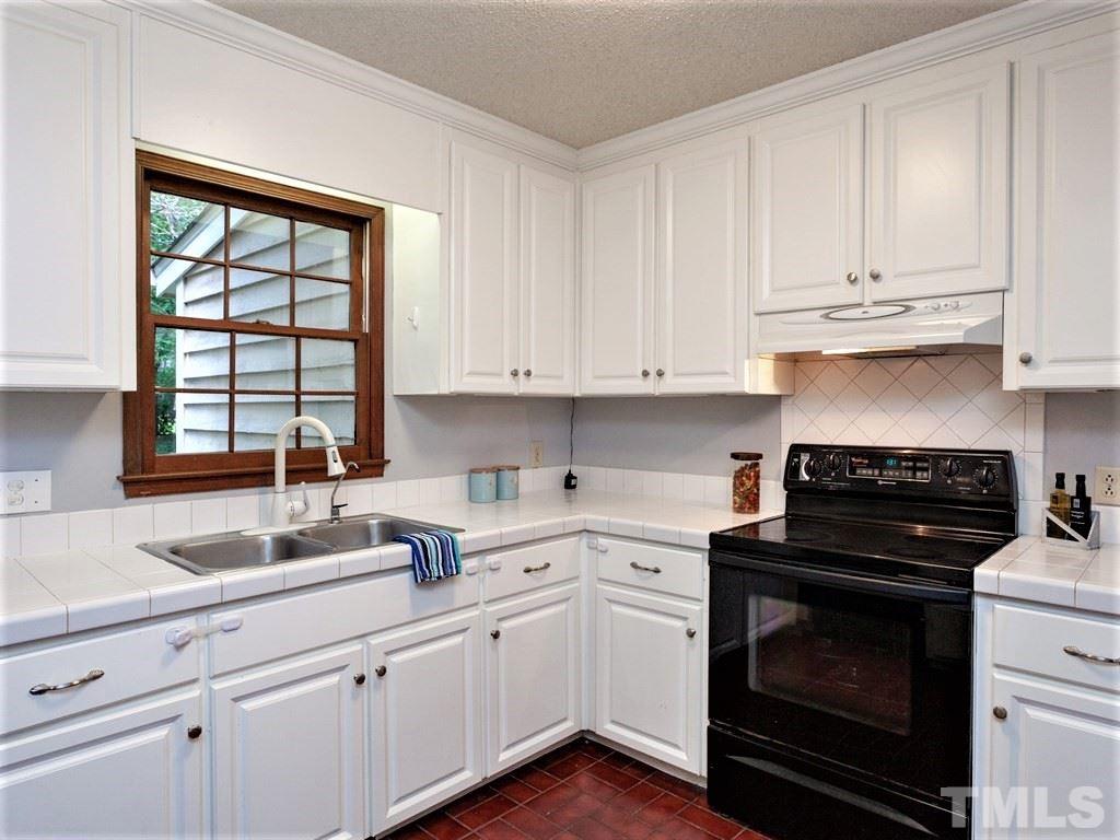 3208 Brennan Drive Raleigh, NC 27613 - Photo 4 of 25 a kitchen with cabinets appliances a sink and a window