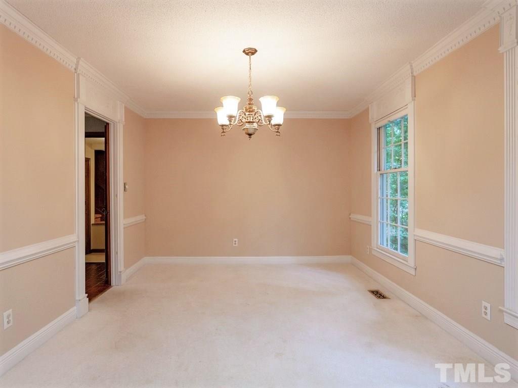 3208 Brennan Drive Raleigh, NC 27613 - Photo 7 of 25 wooden floor in an empty room with a window