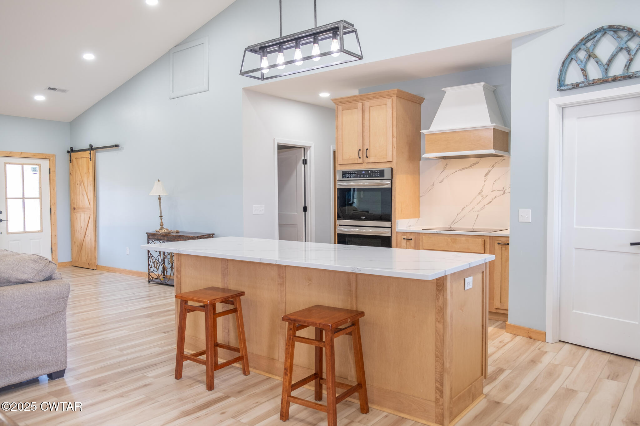 1375 White Clay Road Sharon, TN 38255 - Photo 12 of 58 a view of a kitchen with kitchen island a chandelier and wooden floor