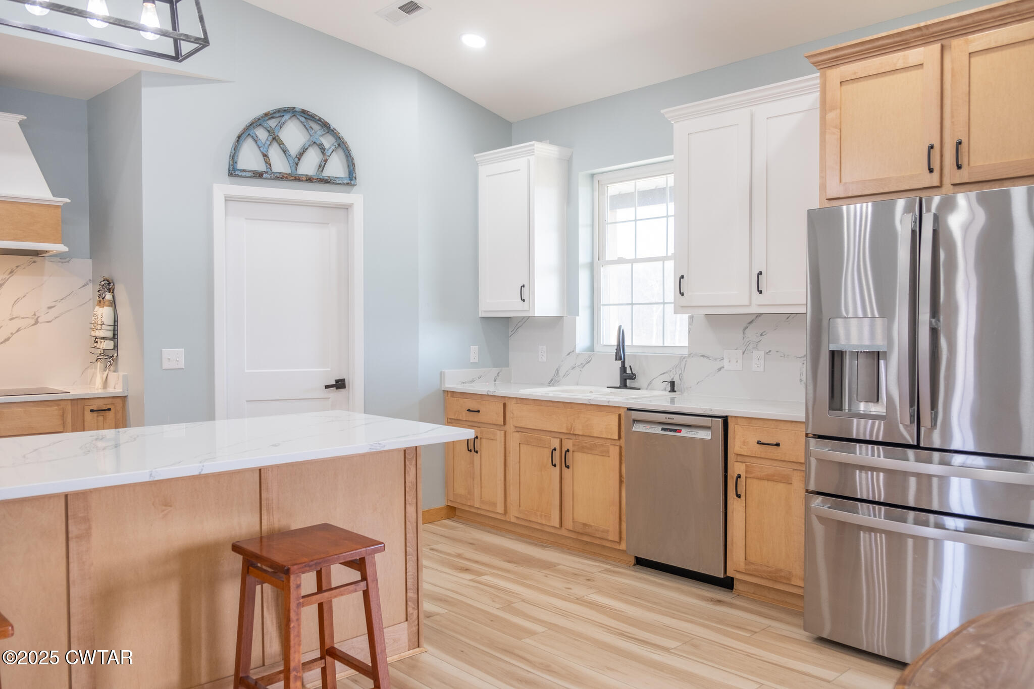 1375 White Clay Road Sharon, TN 38255 - Photo 13 of 58 a kitchen with stainless steel appliances granite countertop a refrigerator a stove a sink and white cabinets with wooden floor