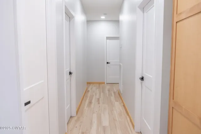 a bathroom with a sink a toilet a mirror and shower