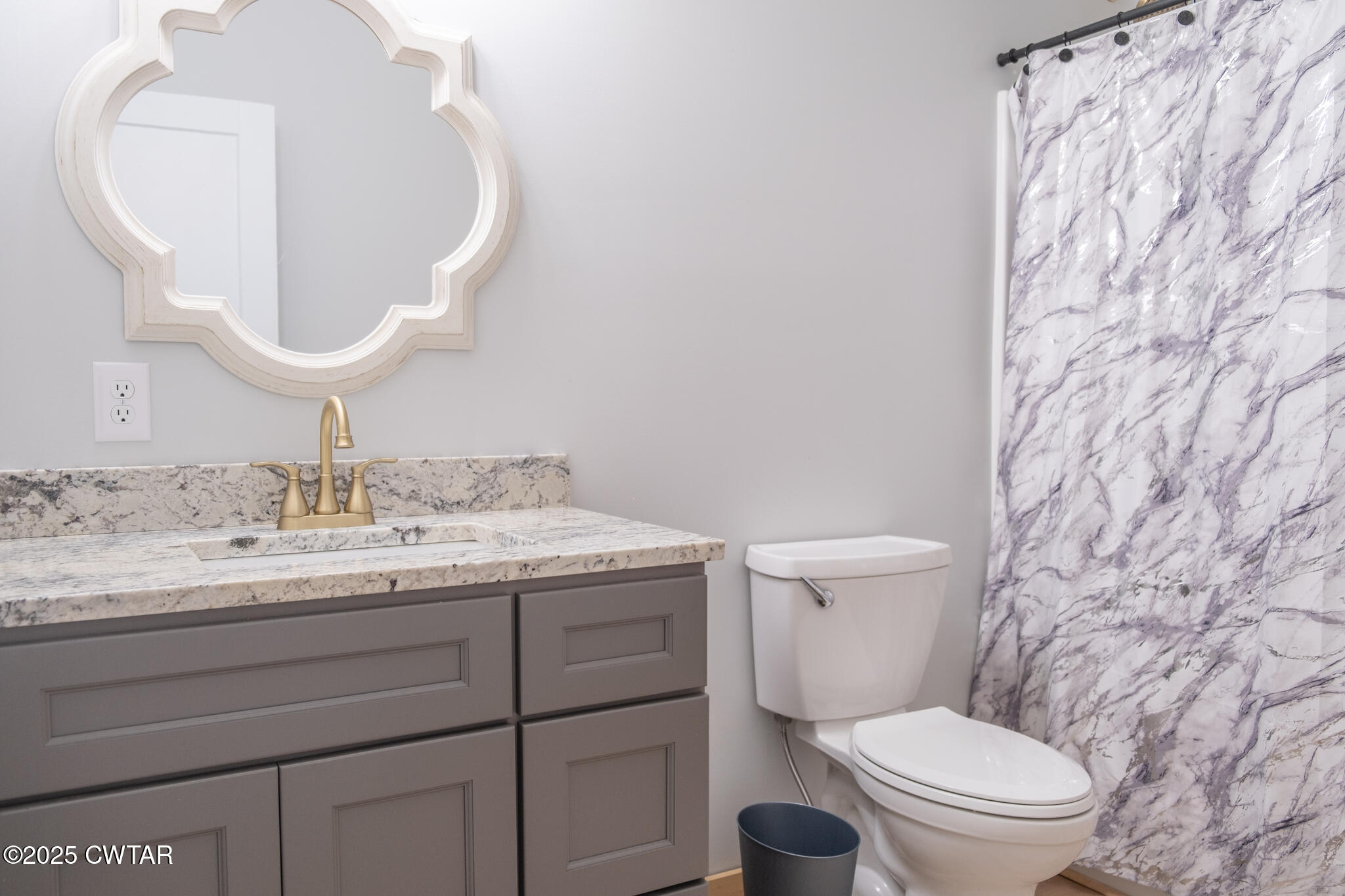 1375 White Clay Road Sharon, TN 38255 - Photo 24 of 38 a bathroom with a granite countertop toilet sink and mirror
