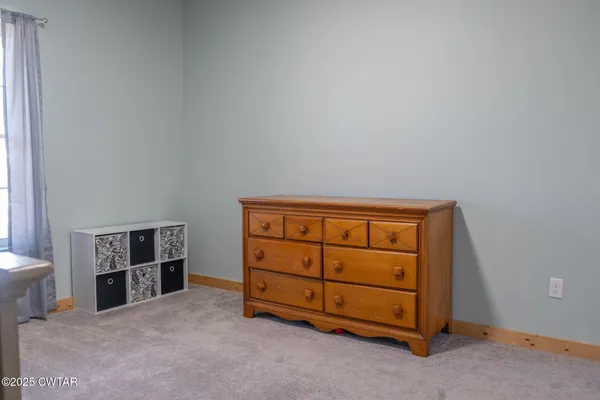 a bed sitting in a room next to a window