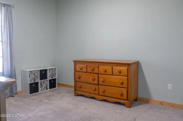 a bed sitting in a room next to a window