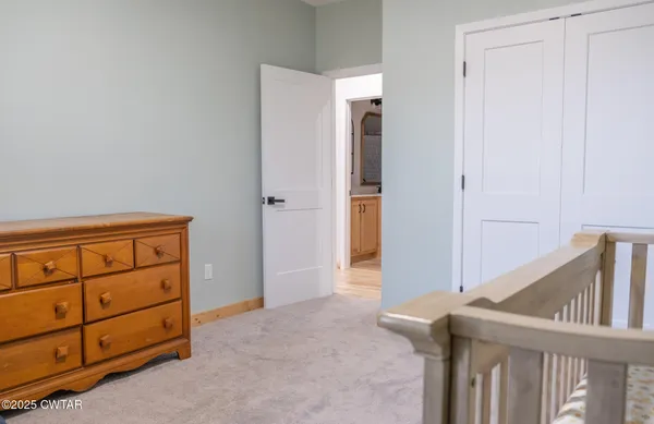a view of a bedroom with furniture and windows