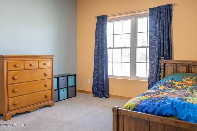 a bathroom with a granite countertop toilet sink and mirror