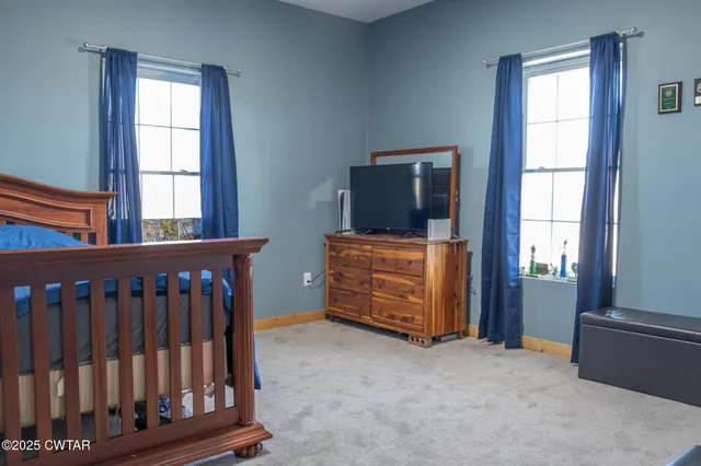 a bed room with a bed and a chair