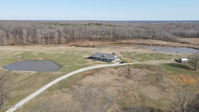 a view of a house with backyard and porch