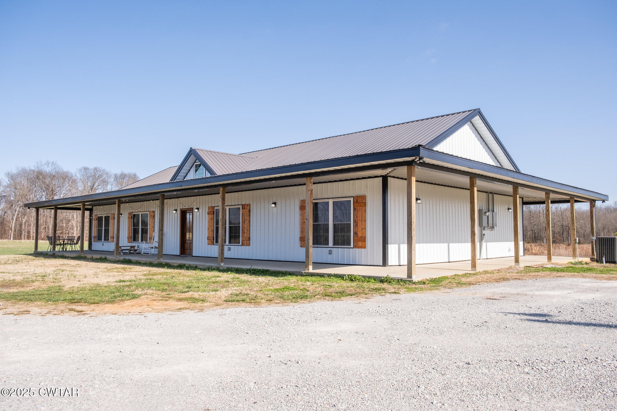 1375 White Clay Road Sharon, TN 38255 - Photo 53 of 58 a big house with large windows and a yard