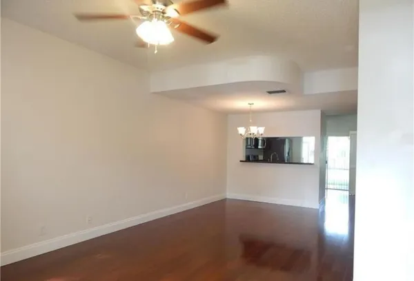 a view of a room with a ceiling fan and a window