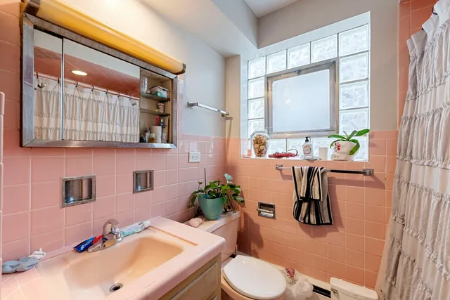 a bathroom with a sink a toilet and a mirror