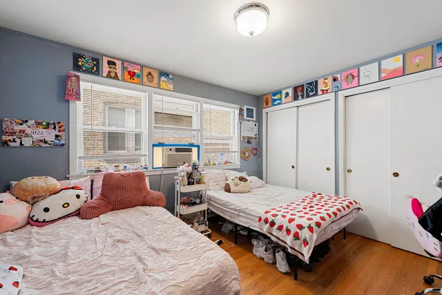 a bedroom with two beds and a large window