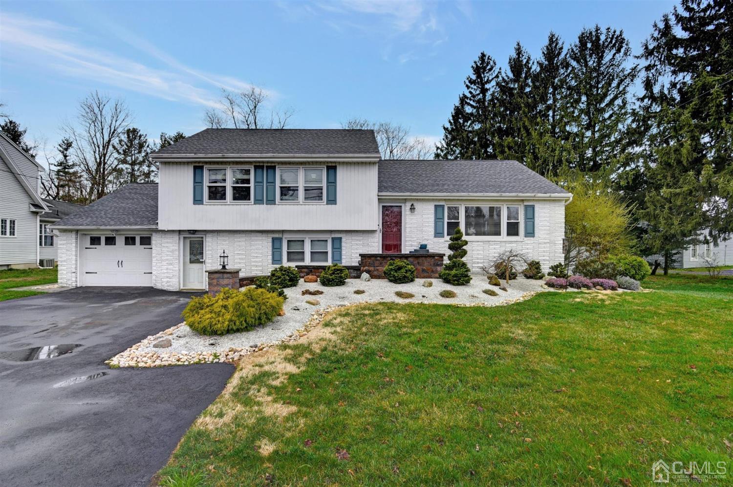 423 Ridge Road Dayton, NJ 08810 - Photo 1 of 29 a front view of a house with a yard patio and fire pit