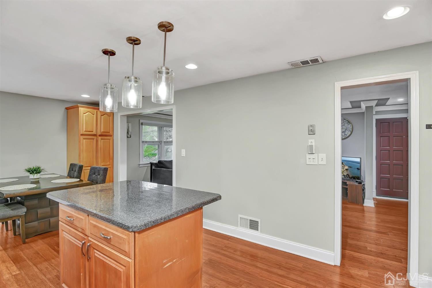 423 Ridge Road Dayton, NJ 08810 - Photo 13 of 29 a kitchen with a table chairs and wooden floor
