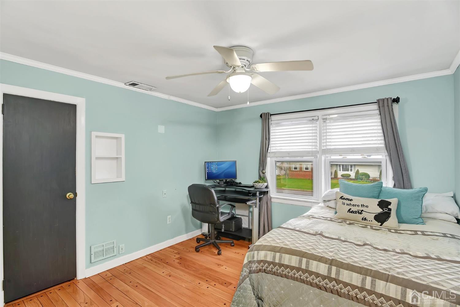 423 Ridge Road Dayton, NJ 08810 - Photo 17 of 29 a bedroom that has a bed and a table in it