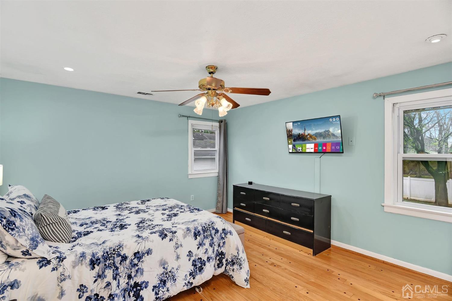 423 Ridge Road Dayton, NJ 08810 - Photo 18 of 29 a bedroom with a bed and a flat screen tv