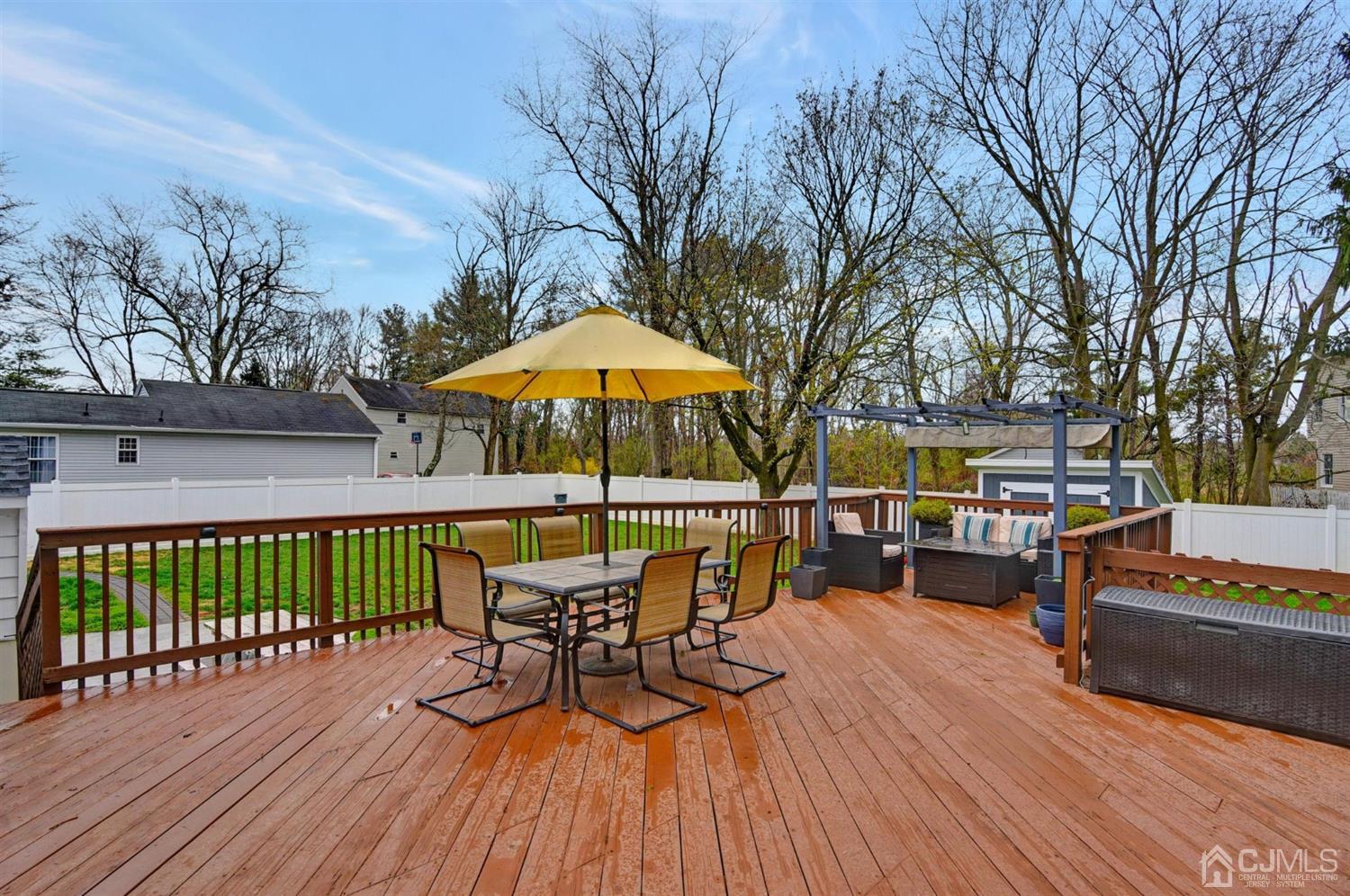 423 Ridge Road Dayton, NJ 08810 - Photo 21 of 29 a view of a house with wooden deck and furniture