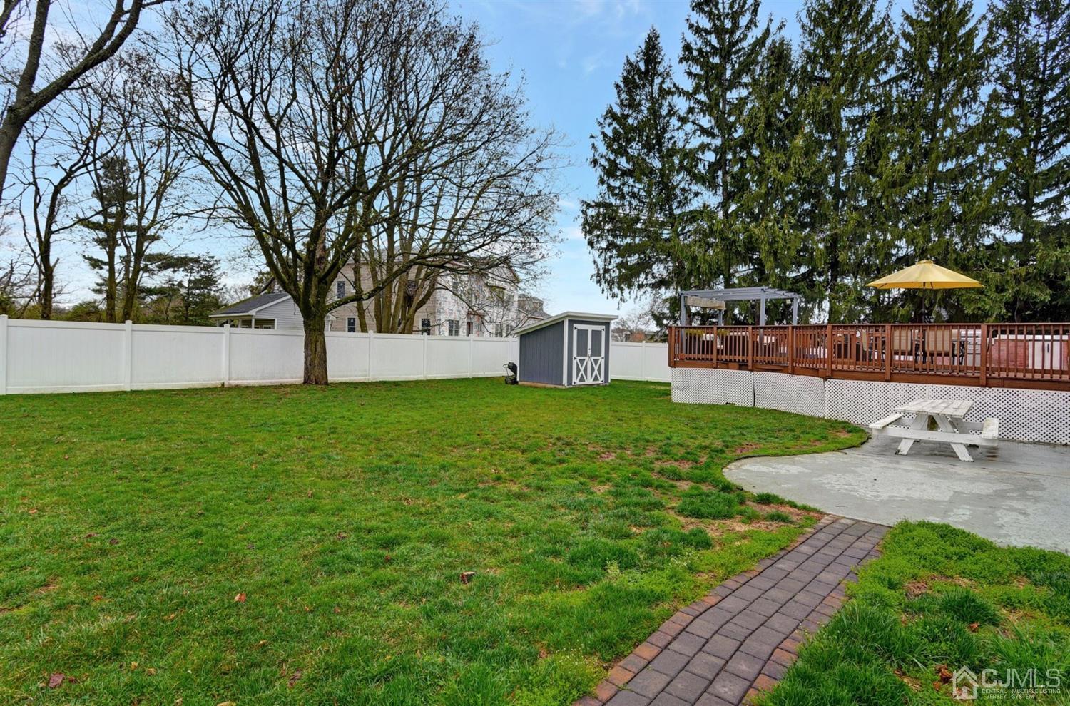 423 Ridge Road Dayton, NJ 08810 - Photo 22 of 29 a view of a backyard with a garden and trees