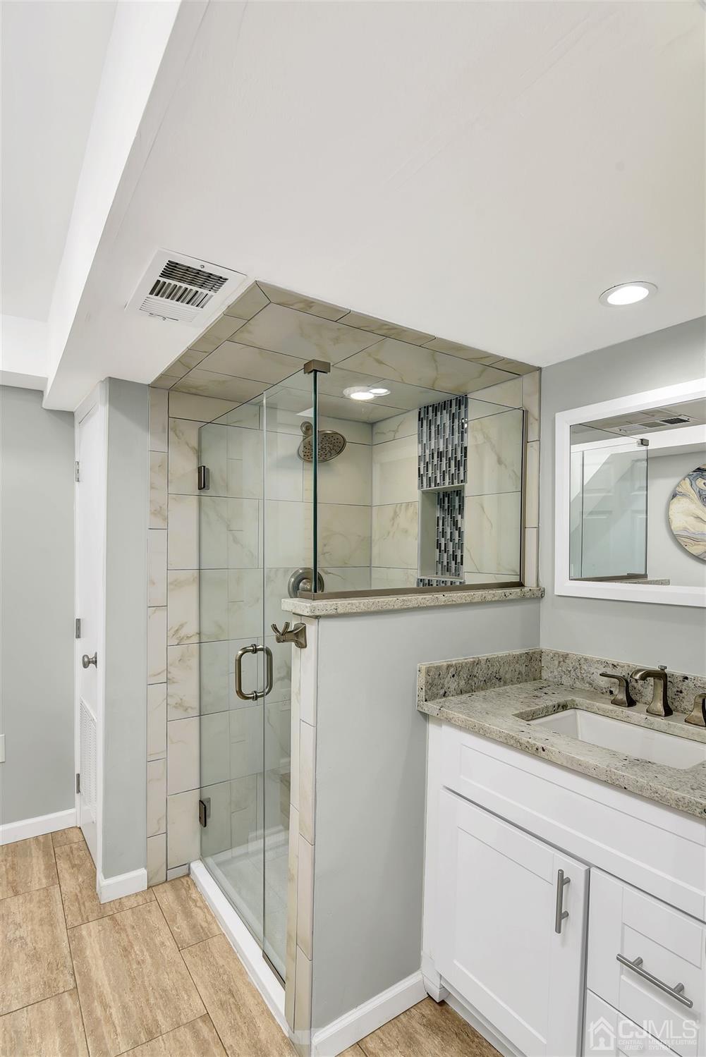 423 Ridge Road Dayton, NJ 08810 - Photo 10 of 29 a bathroom with a granite countertop sink a mirror and shower