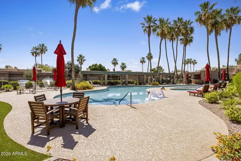 a view of a swimming pool with a table and chairs