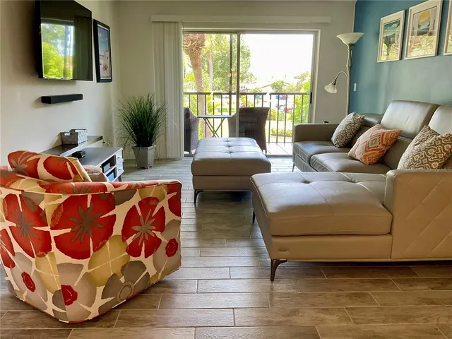 a living room with furniture and a floor to ceiling window