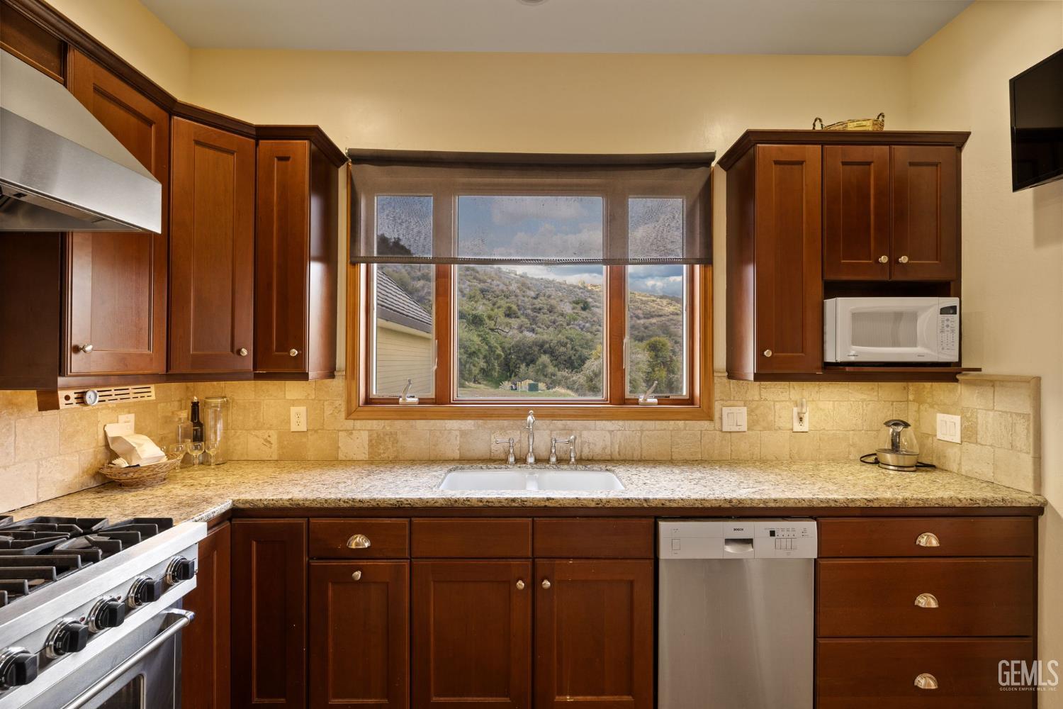 Undisclosed Address Lebec, CA 93243 - Photo 15 of 49 a kitchen with granite countertop a sink and a window