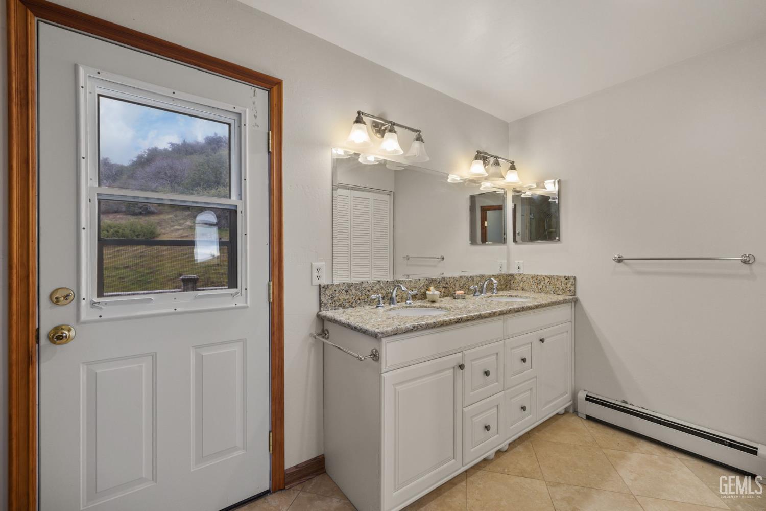 Undisclosed Address Lebec, CA 93243 - Photo 28 of 49 a bathroom with a granite countertop sink and a mirror