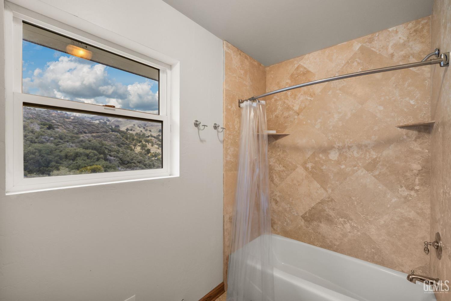 Undisclosed Address Lebec, CA 93243 - Photo 34 of 49 a bathroom with a bathtub and a painting on the wall