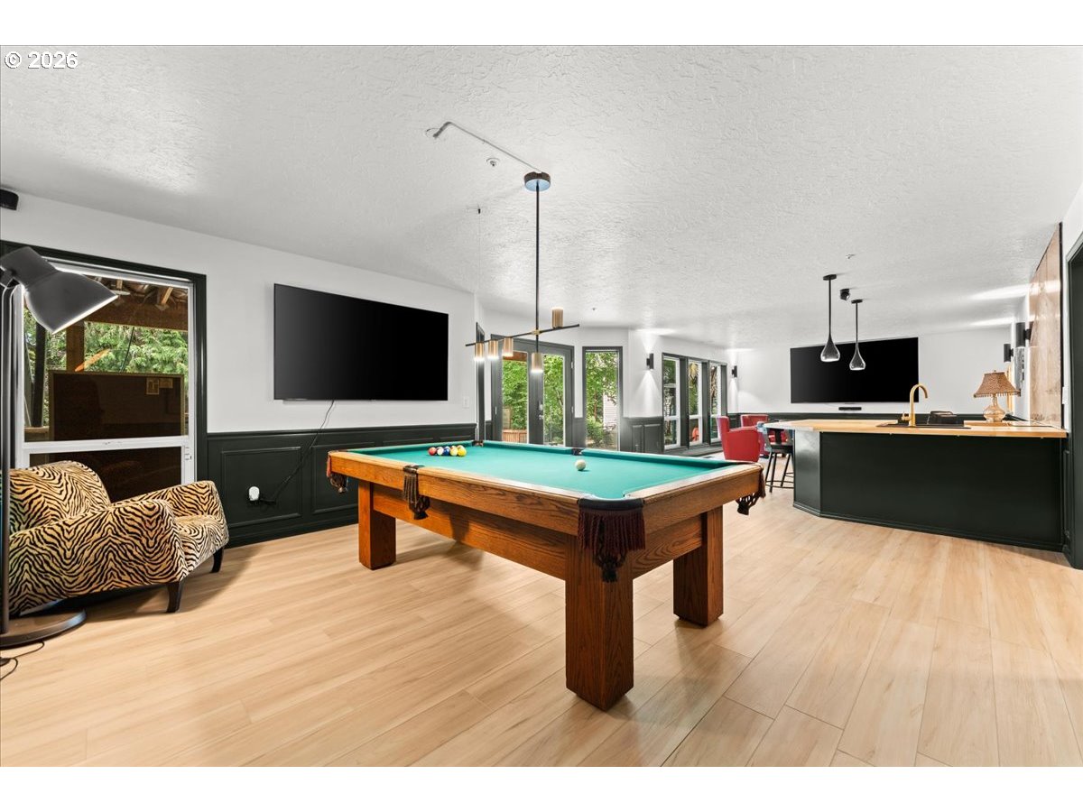 12431 Southwest 55th Place Portland, OR 97219 - Photo 32 of 40 a living room with furniture pool table and flat screen tv