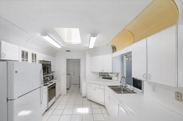 a white refrigerator freezer and a stove in a kitchen