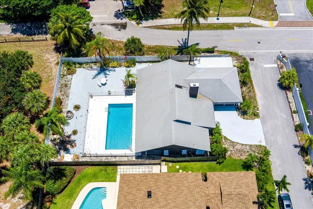 an aerial view of a house with swimming pool and outdoor space