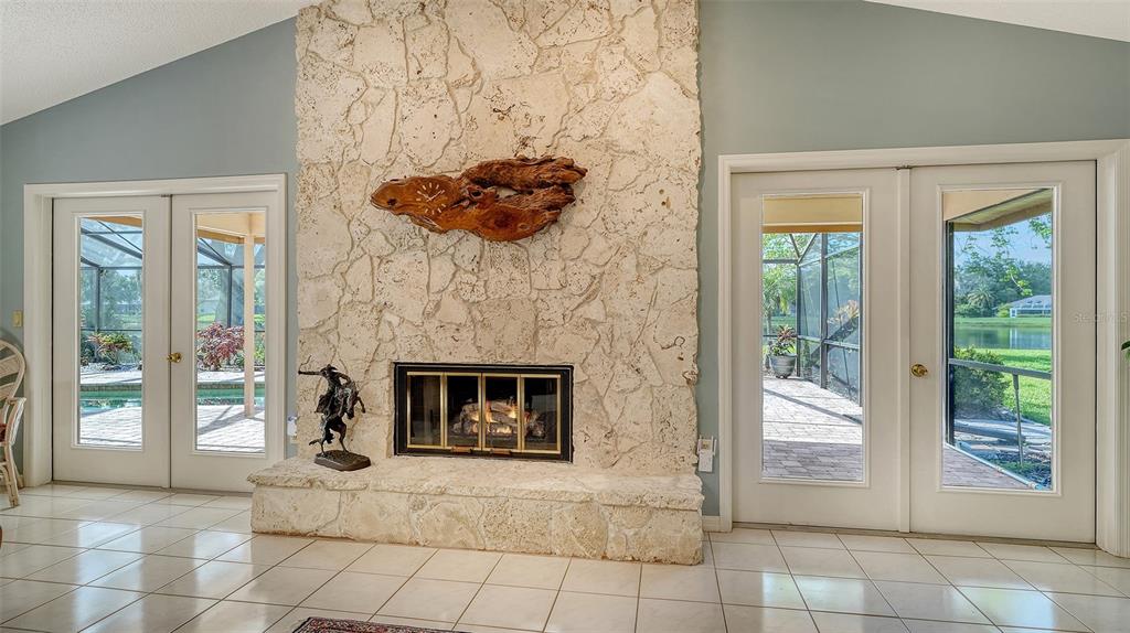 7426 Weeping Willow Boulevard Sarasota, FL 34241 - Photo 18 of 66 a living room with furniture and a fireplace