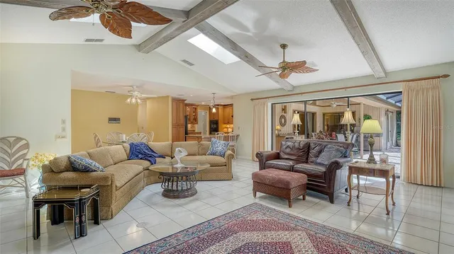 a kitchen with stainless steel appliances granite countertop a refrigerator a sink and white cabinets