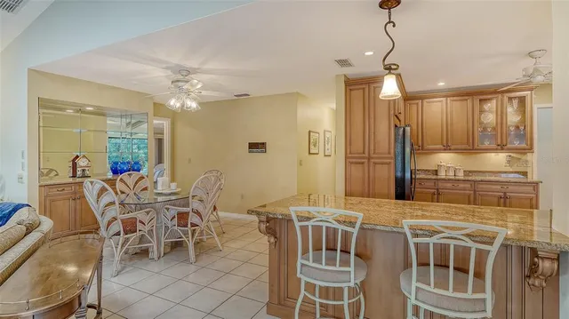 a kitchen with white cabinets and refrigerator